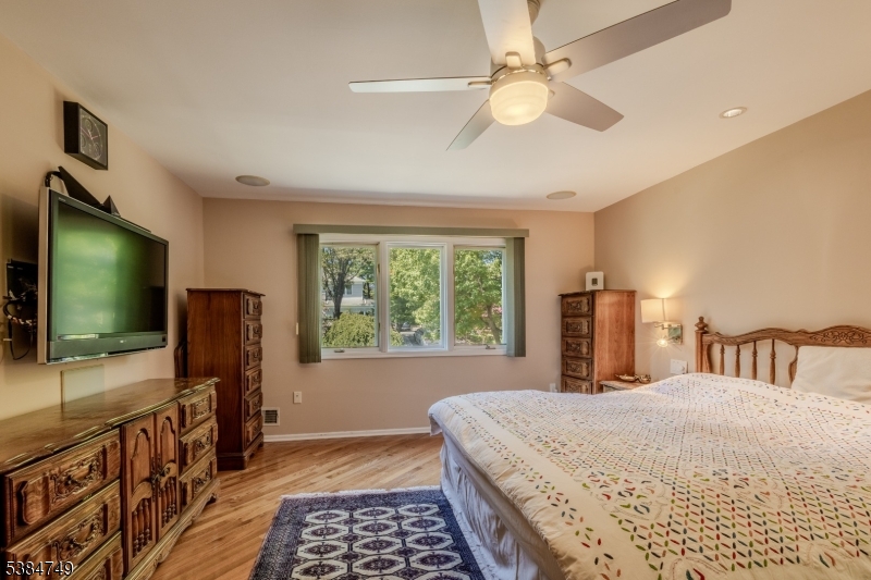 85 Swenson Circle Berkeley Heights, NJ 07922 - Photo 23 of 47 a bedroom with a bed and a flat screen tv