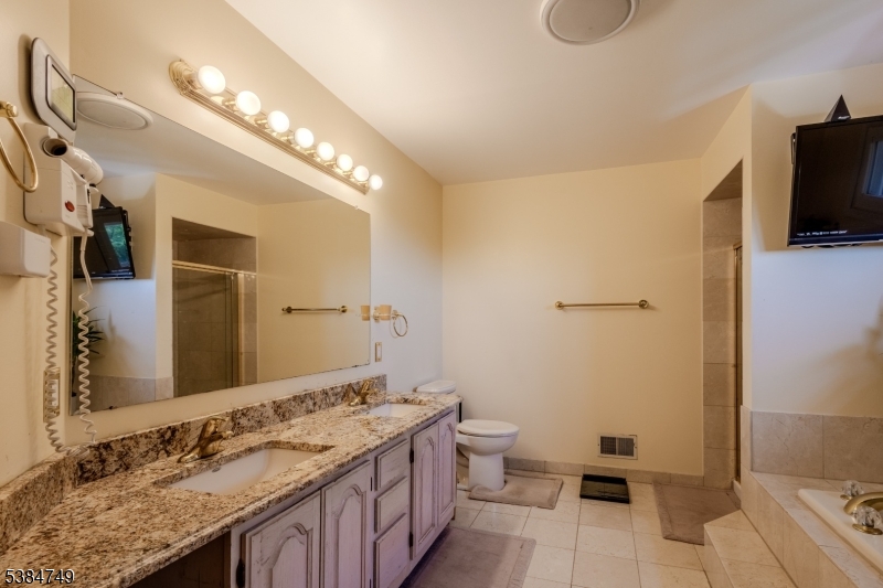 85 Swenson Circle Berkeley Heights, NJ 07922 - Photo 25 of 47 a spacious bathroom with a double vanity sink a mirror and a toilet
