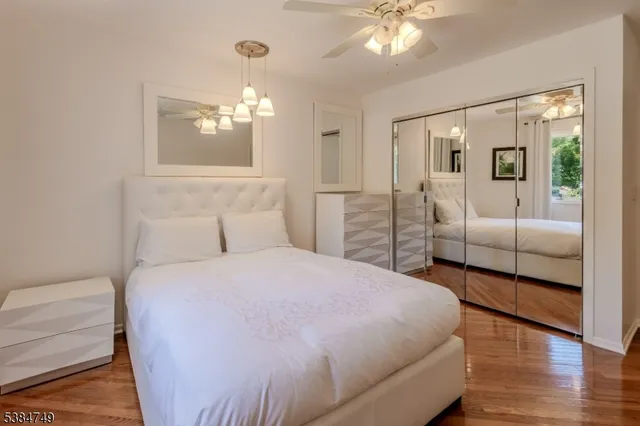 a bedroom with a large bed and a chandelier