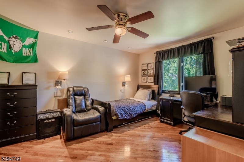 85 Swenson Circle Berkeley Heights, NJ 07922 - Photo 30 of 47 a bedroom with a bed and wooden floor