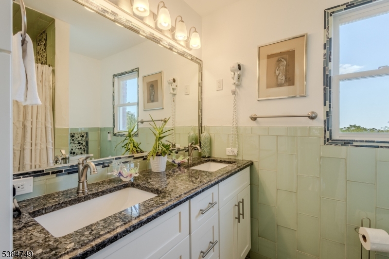 85 Swenson Circle Berkeley Heights, NJ 07922 - Photo 32 of 47 a bathroom with a granite countertop sink a mirror and a shower