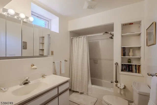 a bathroom with a sink toilet tub and shower
