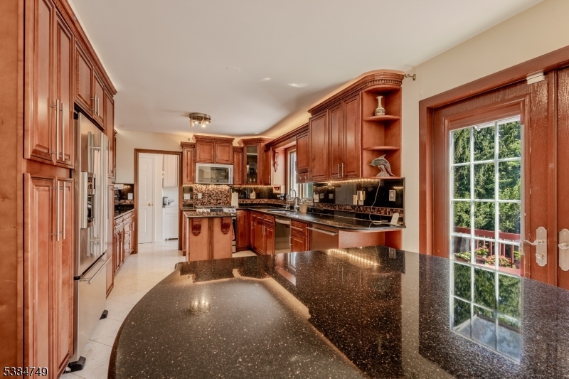 85 Swenson Circle Berkeley Heights, NJ 07922 - Photo 10 of 47 a kitchen with stainless steel appliances granite countertop a refrigerator a stove and a sink with wooden floor