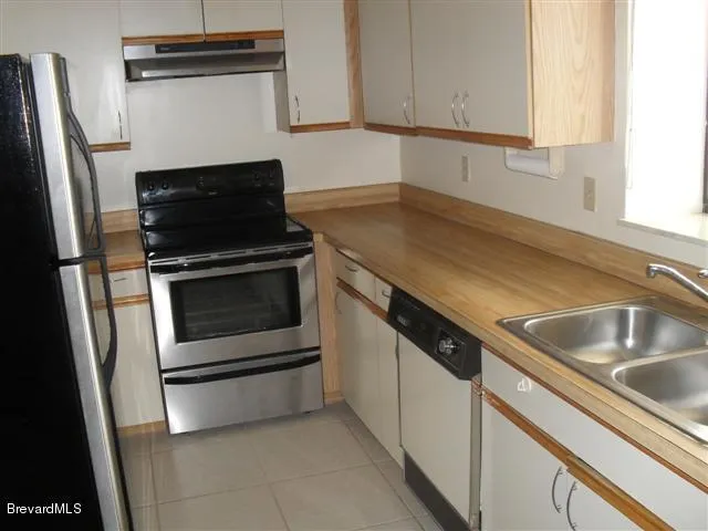 a close view of a kitchen stove a sink and dishwasher