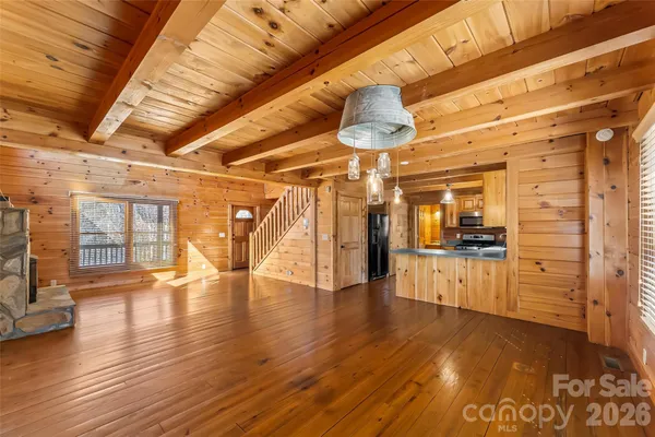 a view of a room with wooden floors
