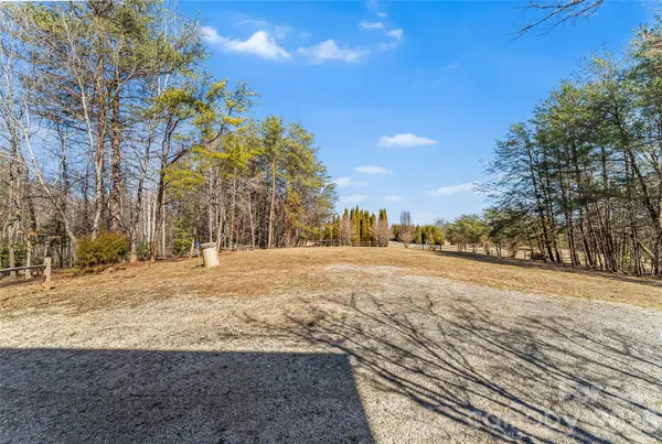 a view of a yard with wooden fence