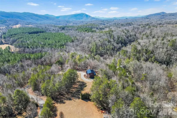 an aerial view of a house with mountain view