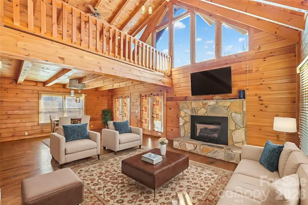 a living room with furniture a fireplace and a flat screen tv