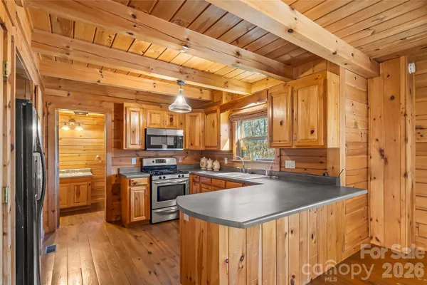 a kitchen with stainless steel appliances granite countertop a sink a stove and a refrigerator
