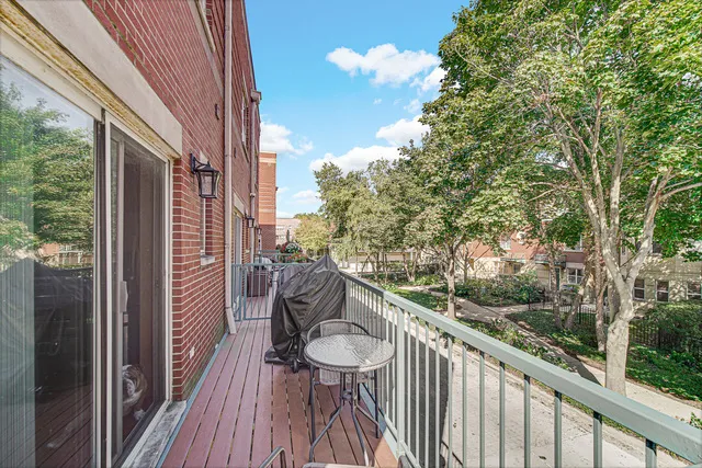 a view of a balcony with furniture and wooden floor