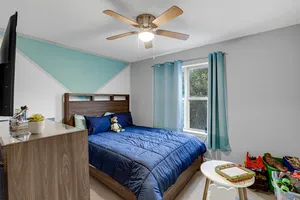 a bedroom with a bed and a chandelier