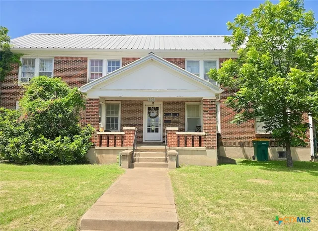 a house with garden in front of it
