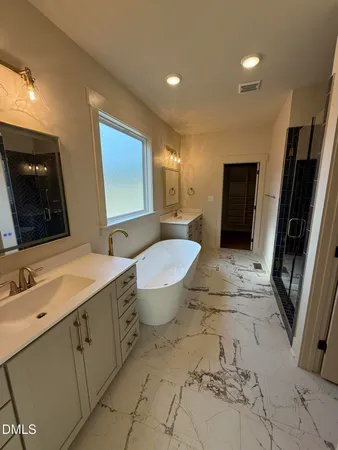 a spacious bathroom with a toilet sink and mirror