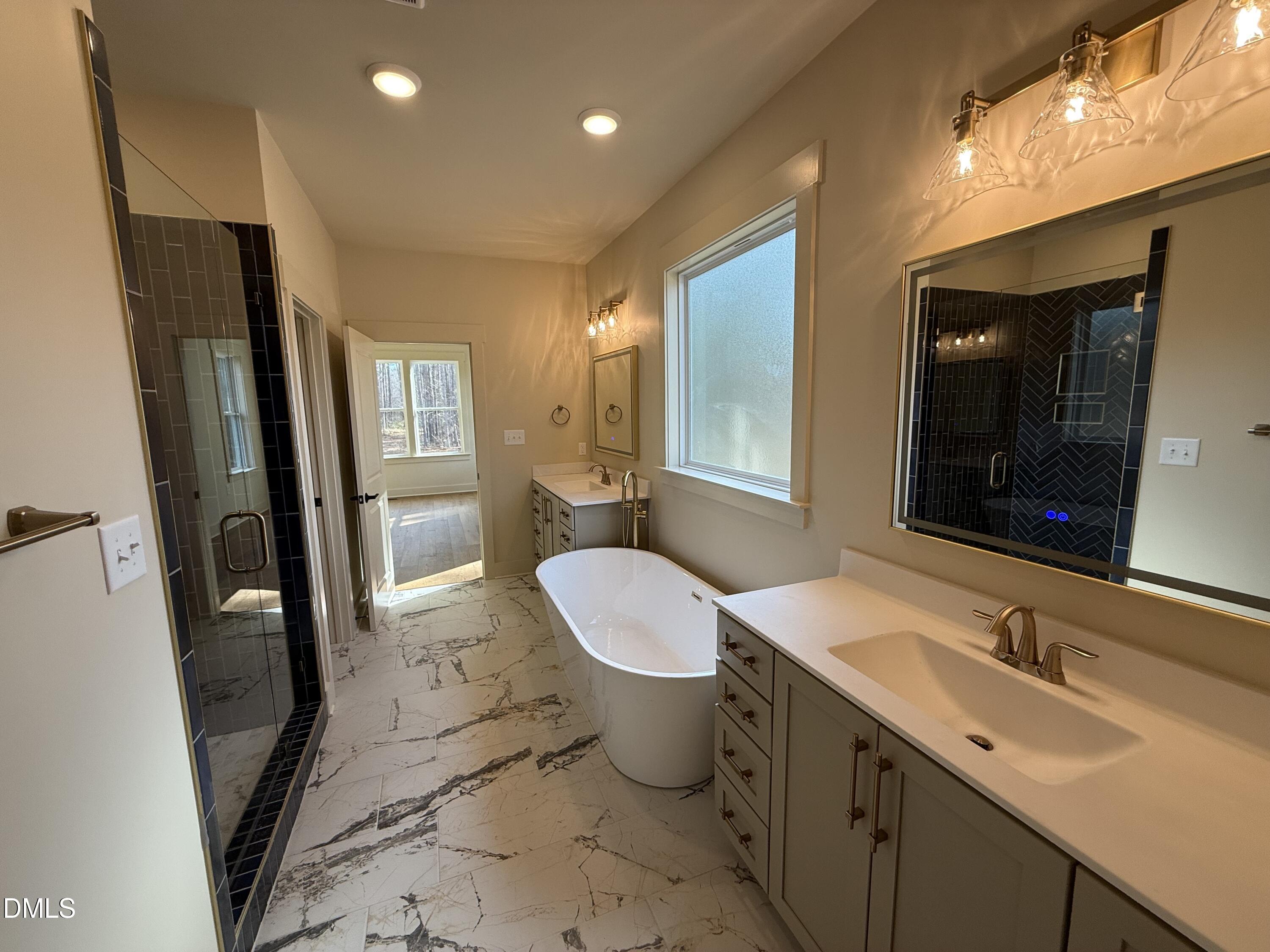 12601 Burgess Road Middlesex, NC 27557 - Photo 17 of 27 a bathroom with a granite countertop sink toilet and shower