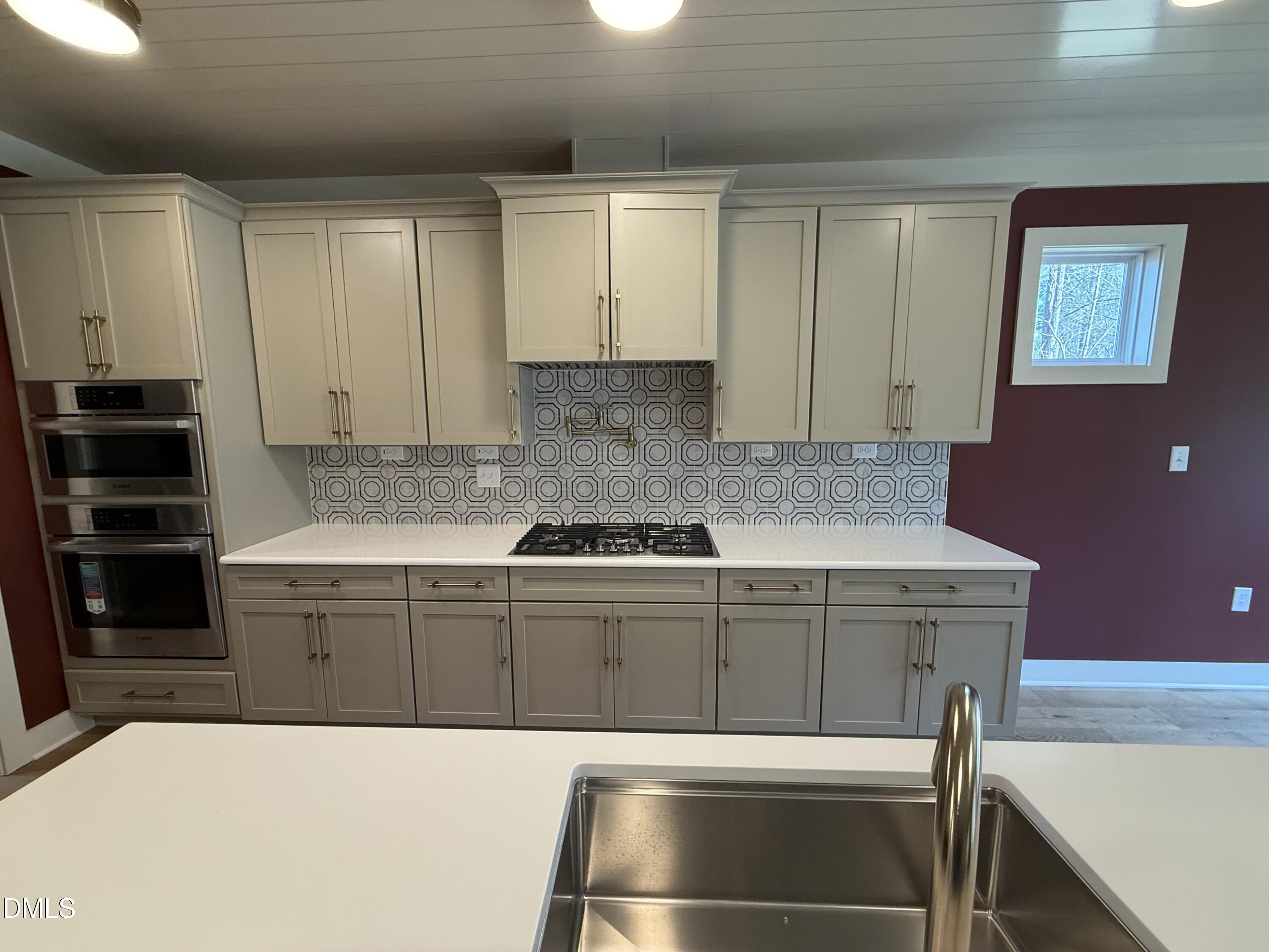 12601 Burgess Road Middlesex, NC 27557 - Photo 7 of 27 a kitchen with kitchen island a stove and a sink