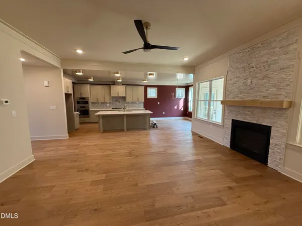 a view of a living room a kitchen and a fireplace