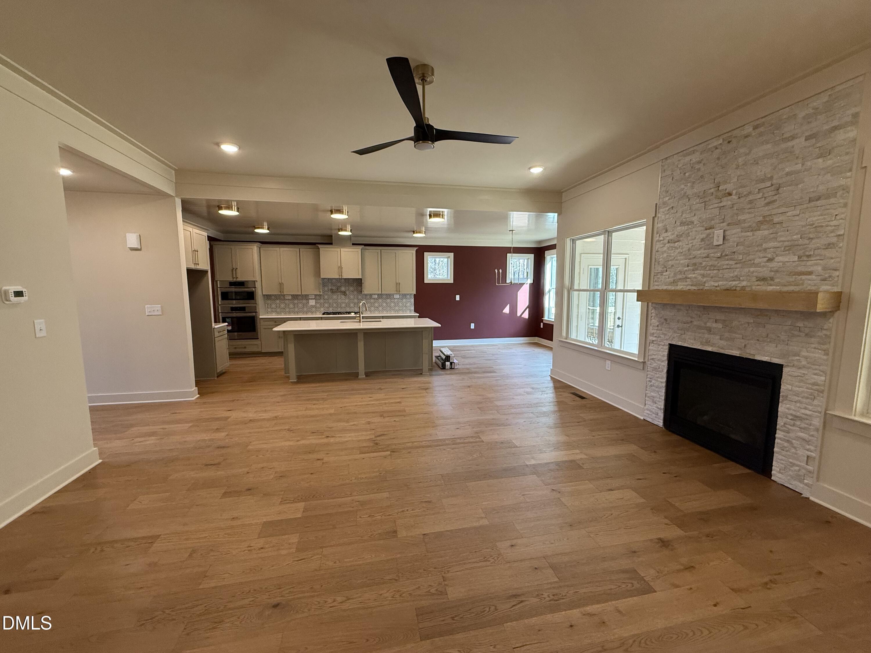 12601 Burgess Road Middlesex, NC 27557 - Photo 9 of 27 a view of a living room a kitchen and a fireplace