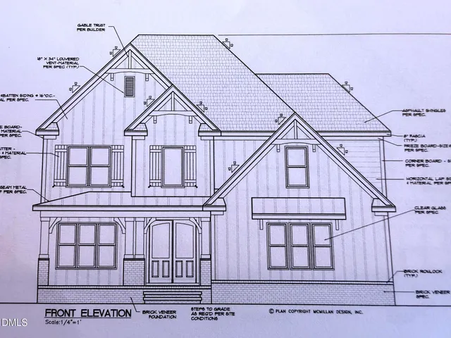 a white building with a small yard