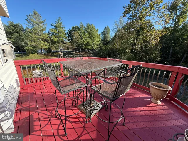 a view of an outdoor sitting area with brick wall