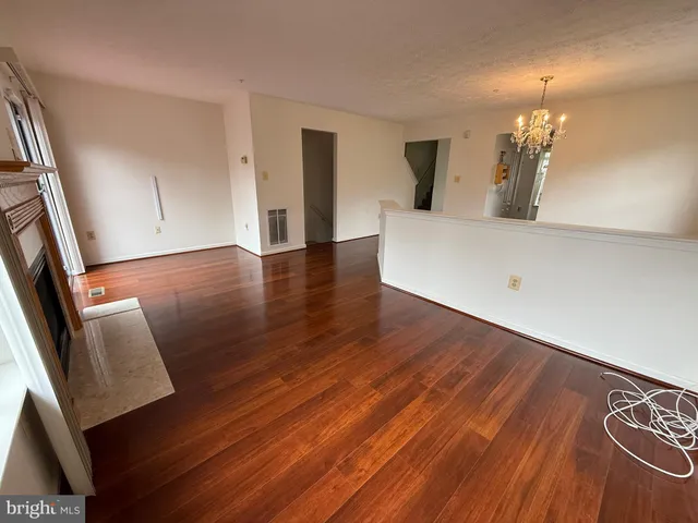 a view of a living room with wooden floor