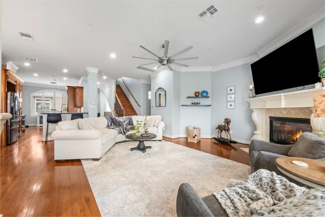 a living room with furniture a flat screen tv and a fireplace
