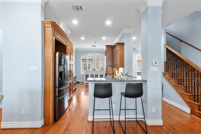 a view of a dining room with furniture a chandelier and wooden floor