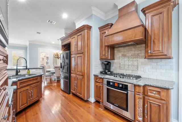 a kitchen with stainless steel appliances granite countertop a stove and a refrigerator