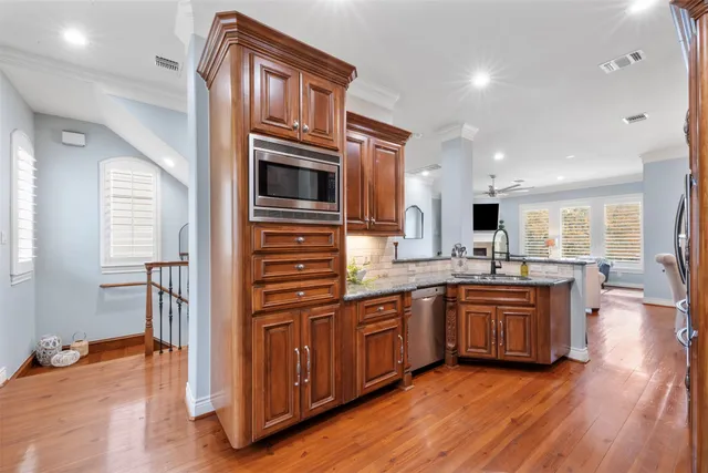 a kitchen with stainless steel appliances granite countertop a stove and a sink