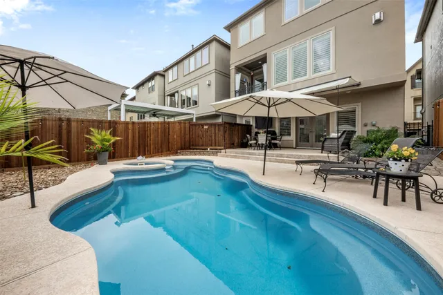 a view of a patio with swimming pool table and chairs