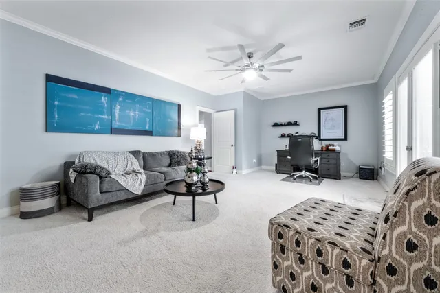 a spacious bedroom with a bed couch and a window