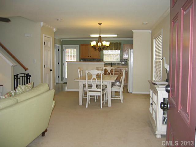 10410 Caldwell Depot Road Cornelius, NC 28031 - Photo 3 of 15 a dining room with furniture a chandelier and window