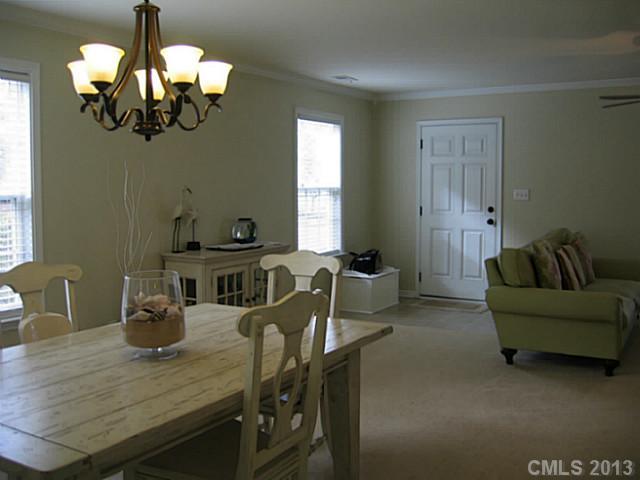 10410 Caldwell Depot Road Cornelius, NC 28031 - Photo 4 of 15 a view of a dining room with furniture a chandelier and wooden floor
