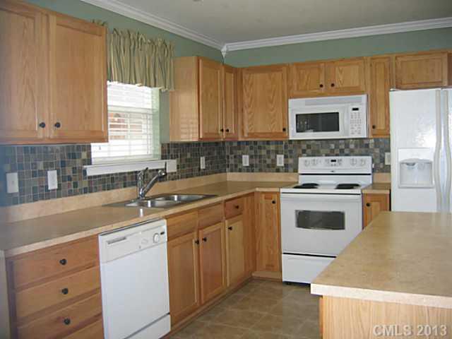 10410 Caldwell Depot Road Cornelius, NC 28031 - Photo 6 of 15 a kitchen with cabinets appliances a sink and a window