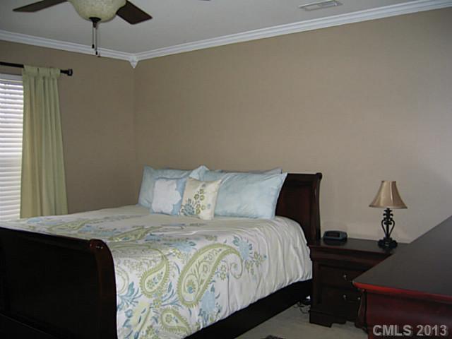 10410 Caldwell Depot Road Cornelius, NC 28031 - Photo 8 of 15 a bedroom with a bed and wooden floor