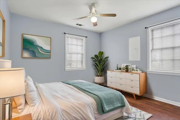 a bedroom with a bed and a chandelier
