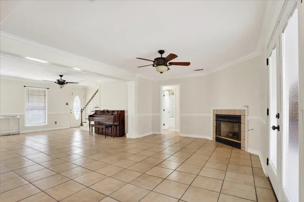 a view of an empty room and a ceiling fan