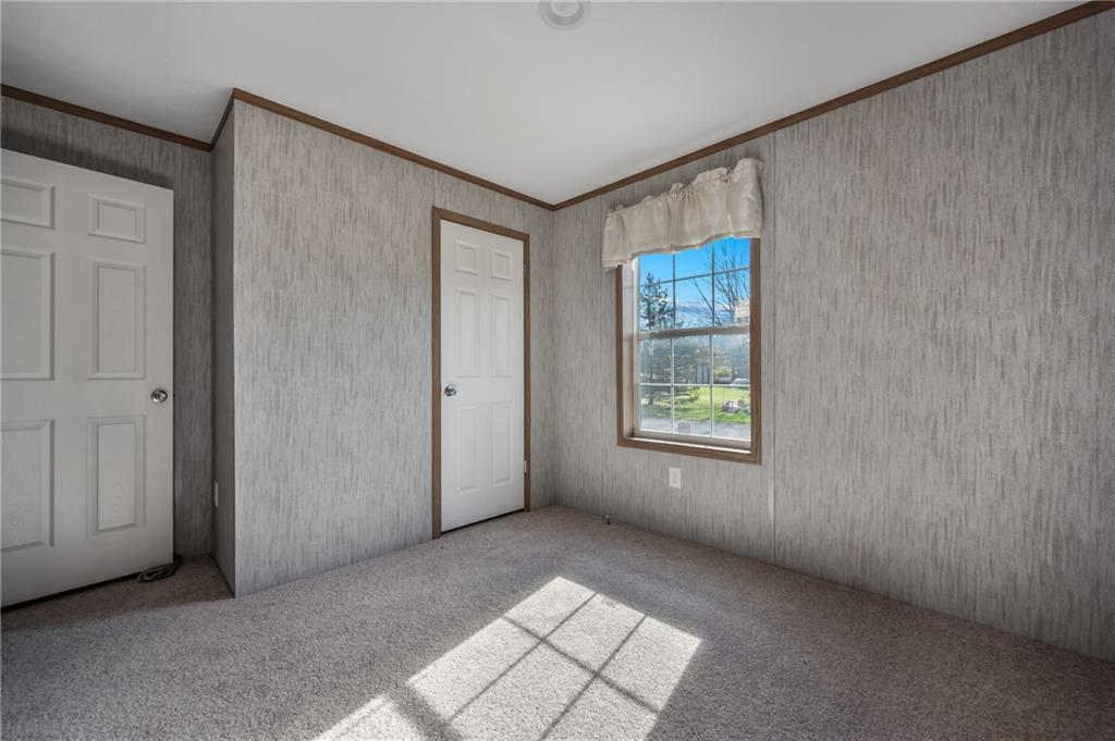 69 South Summit Road, Unit 102 Greenville, PA 16125 - Photo 21 of 24 a view of an empty room with window and closet area