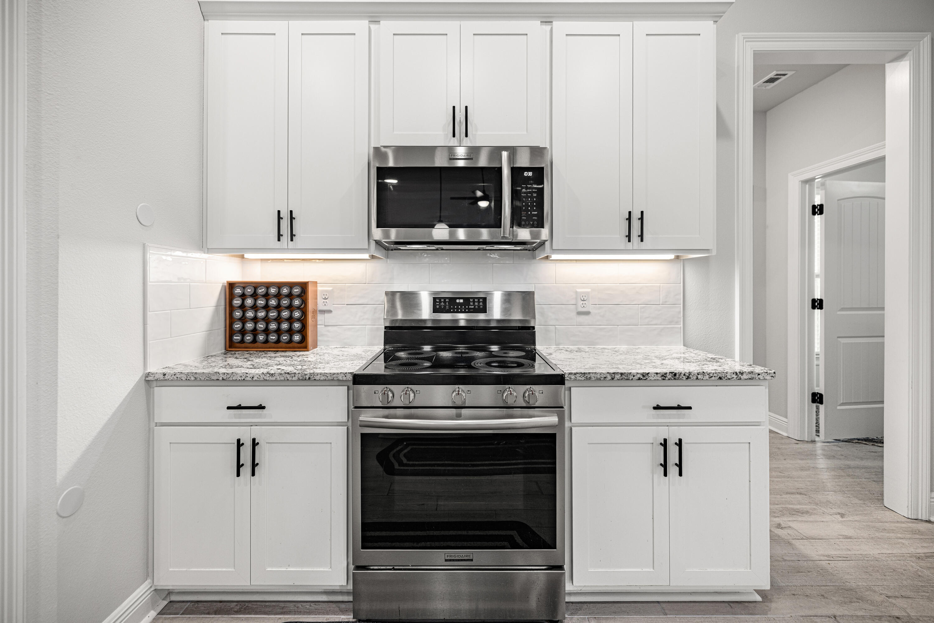 132 East Tweet Street Freeport, FL 32439 - Photo 16 of 79 a kitchen with stainless steel appliances white cabinets and a stove top oven