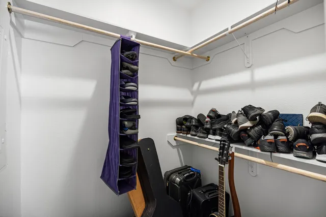 a view of an empty room and a ceiling fan