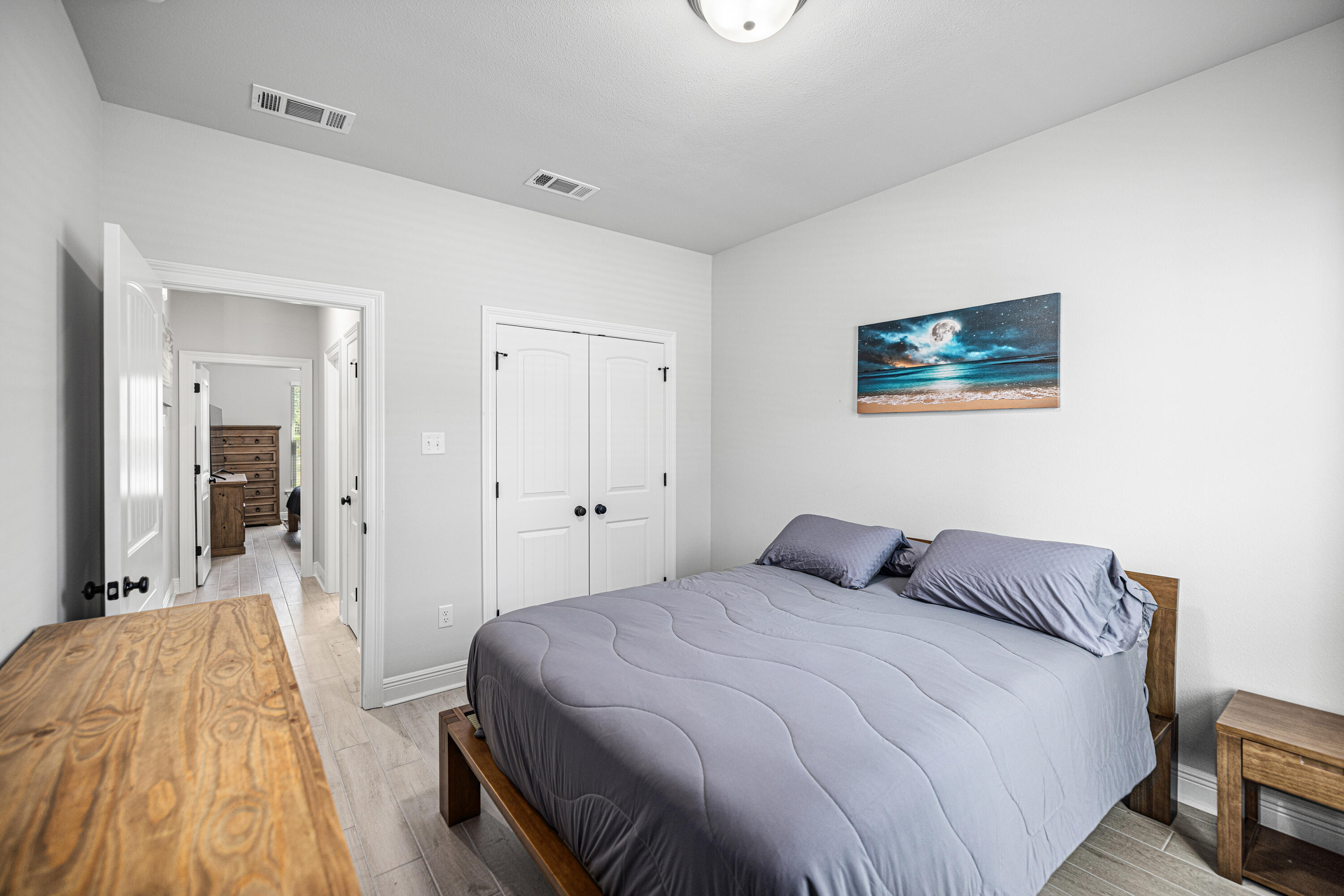 132 East Tweet Street Freeport, FL 32439 - Photo 27 of 79 a bedroom with a bed and a painting on the wall