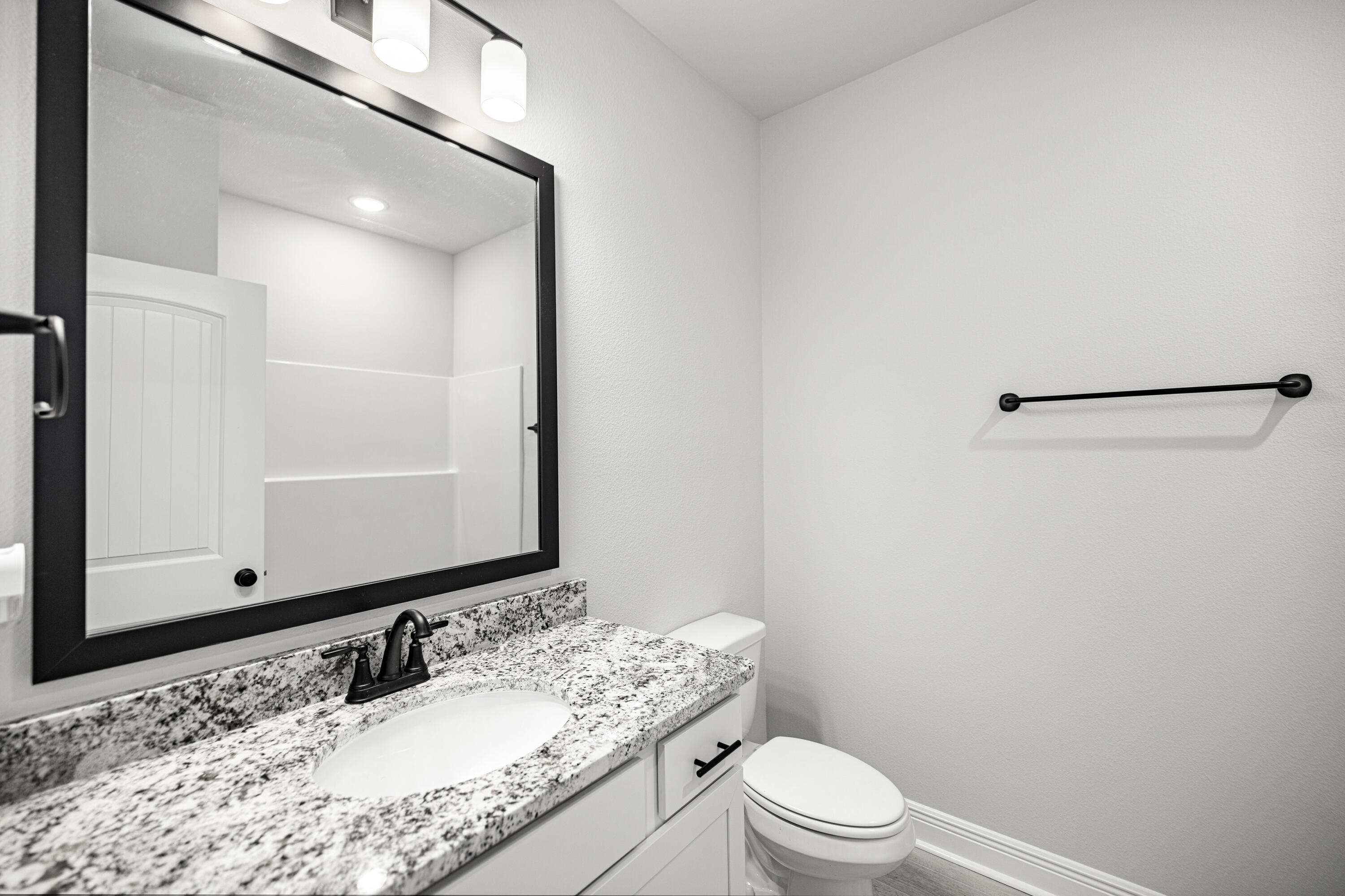 132 East Tweet Street Freeport, FL 32439 - Photo 28 of 79 a bathroom with a granite countertop sink toilet and a mirror