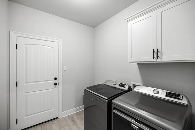 a large kitchen with a table and chairs