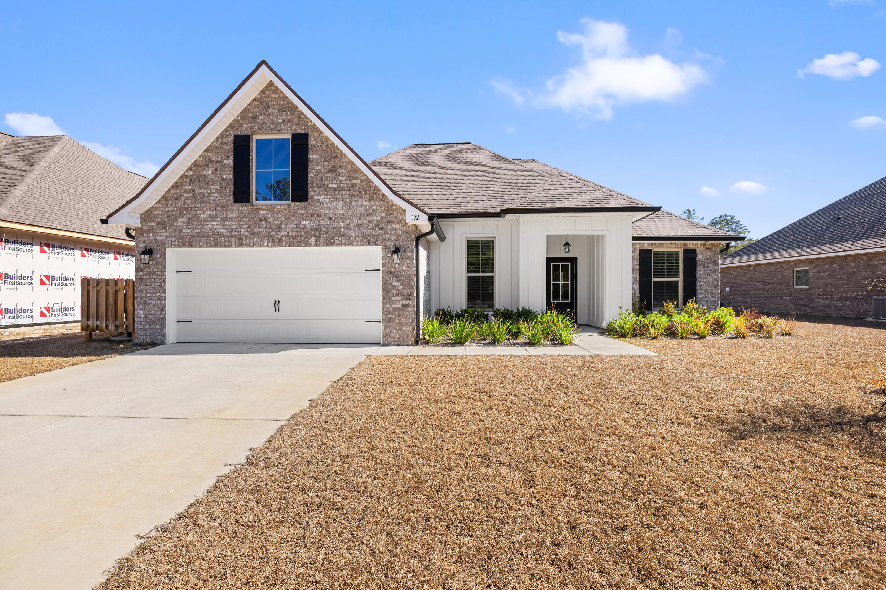 132 East Tweet Street Freeport, FL 32439 - Photo 4 of 79 a front view of a house with a yard and garage