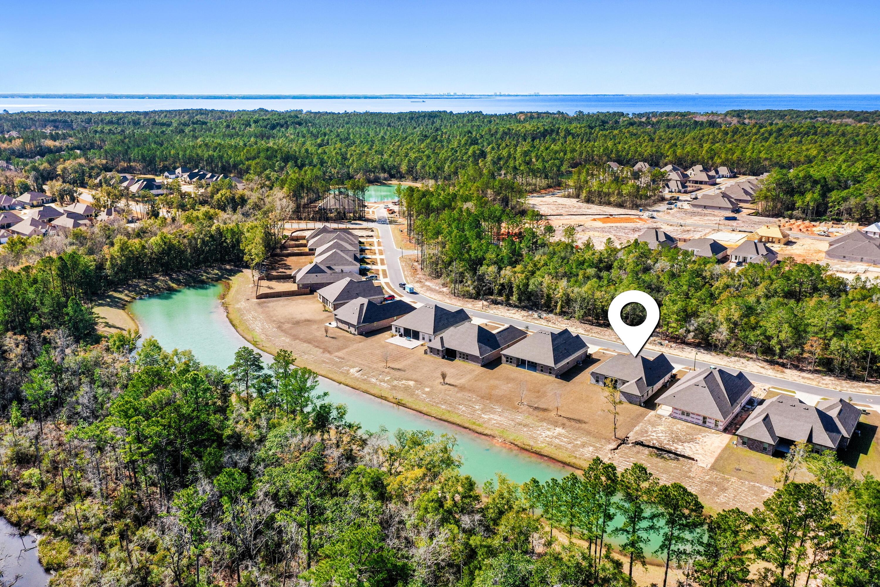 132 East Tweet Street Freeport, FL 32439 - Photo 46 of 79 an aerial view of a house with a garden and lake view