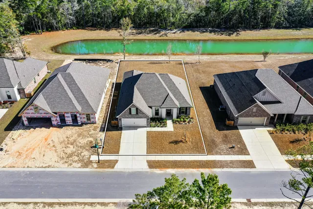 a view of a room with gym equipment and lots of potted plants