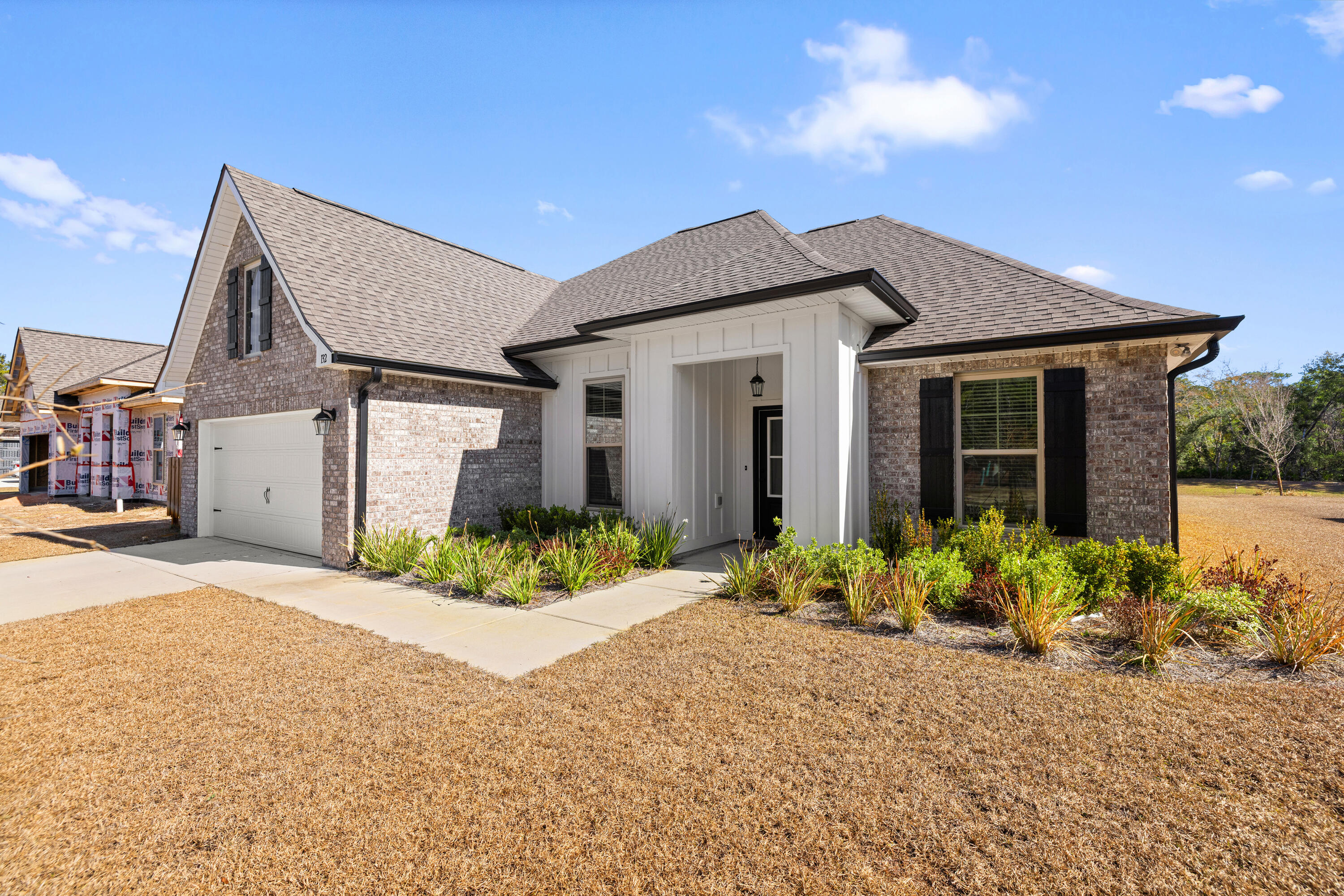 132 East Tweet Street Freeport, FL 32439 - Photo 5 of 79 a front view of a house with a yard and potted plants