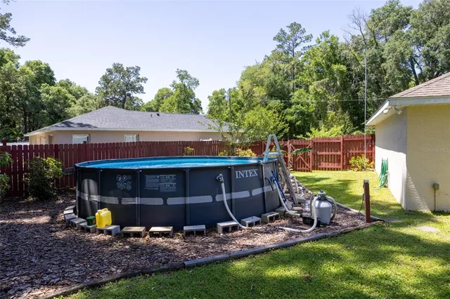 a view of house with backyard space and balcony