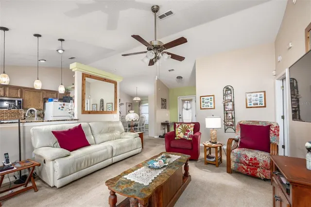 a living room with furniture a rug and a chandelier