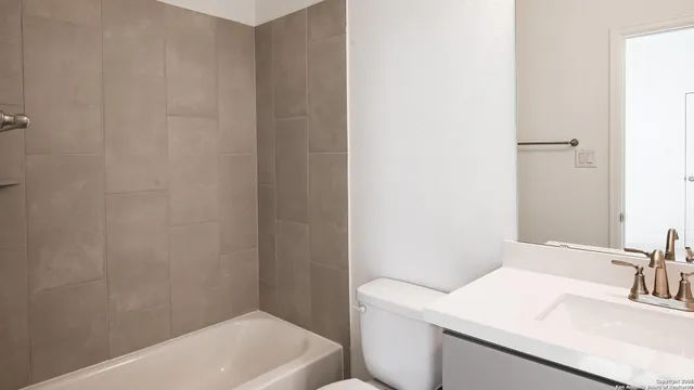 a bathroom with a sink toilet and tub