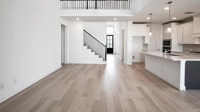 a view of an empty room with wooden floor